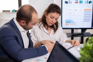 Colleagues of startup business discussing looking at documents