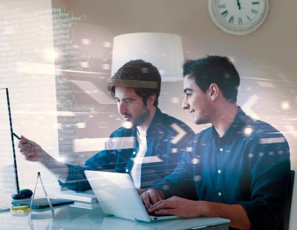 Two men working on laptop