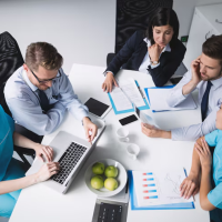 Business meeting, shared laptop