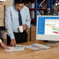 Managers reviewing warehouse data
