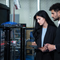 Engineers inspecting server cabinet